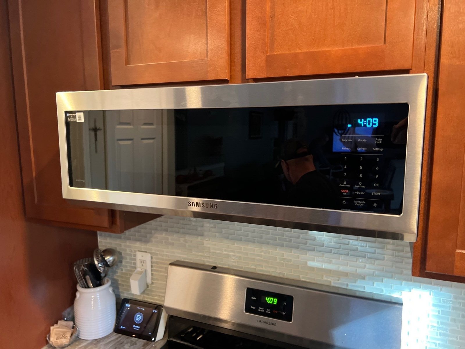 a slim over the range microwave oven with a hood vent