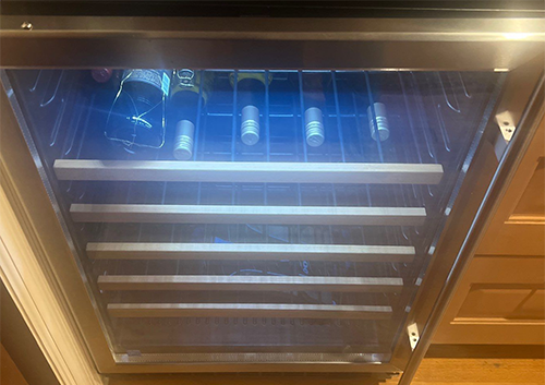 a wine cooler with bottles of wine in it